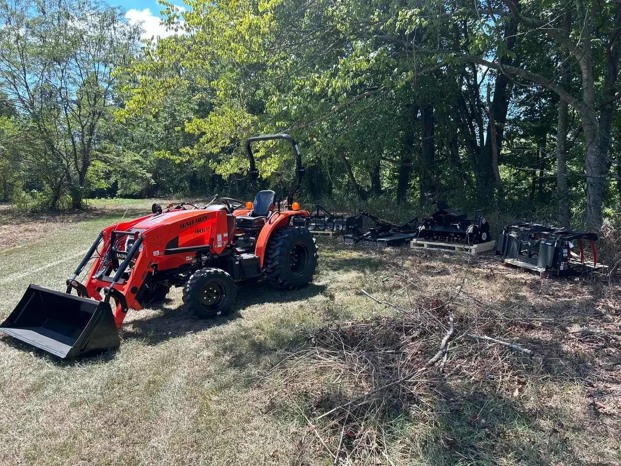 Tractor and implements clearing brush