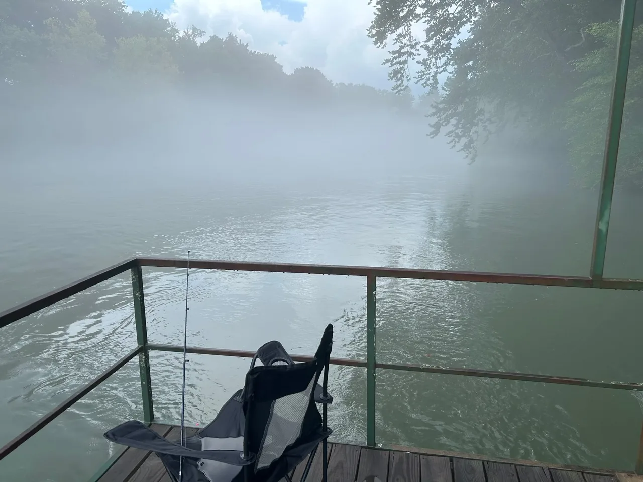 Fishing chair on the dock in morning fog